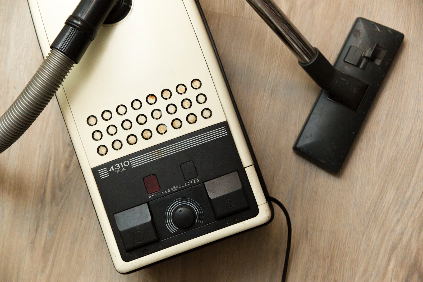 black vacuum cleaner on brown wooden surface